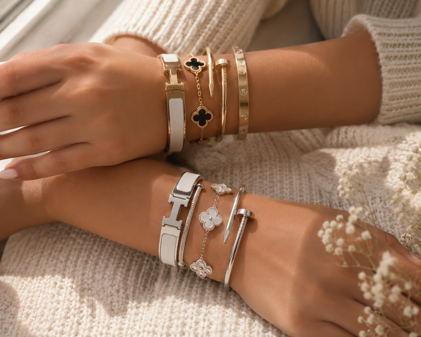 Gold and silver bracelet stacks styled on cream knit